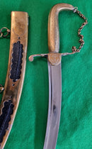 An early Georgian Naval Dirk by Collins 52 Strand. Solid brass hilt and decorative brass scabbard etched with trophy of arms.