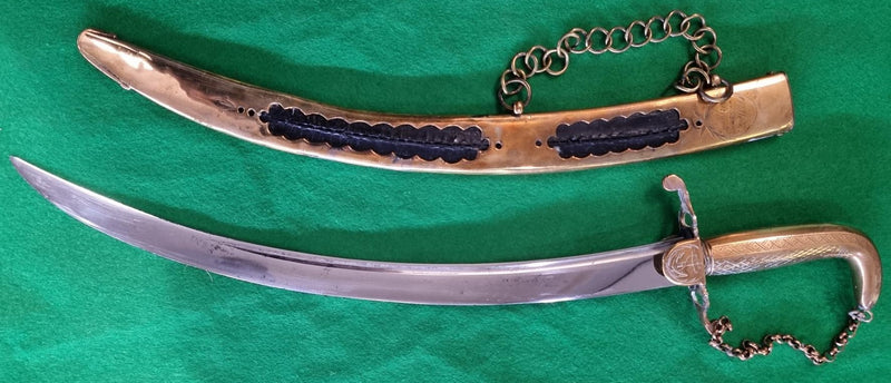 An early Georgian Naval Dirk by Collins 52 Strand. Solid brass hilt and decorative brass scabbard etched with trophy of arms.